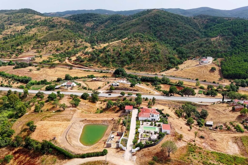 Comprehensive aerial view of Hillside Sanctuary estate with multiple buildings and pool